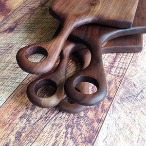 beautiful walnut charcuterie serving cutting board with hand carved handle by Michael's Woodcrafts