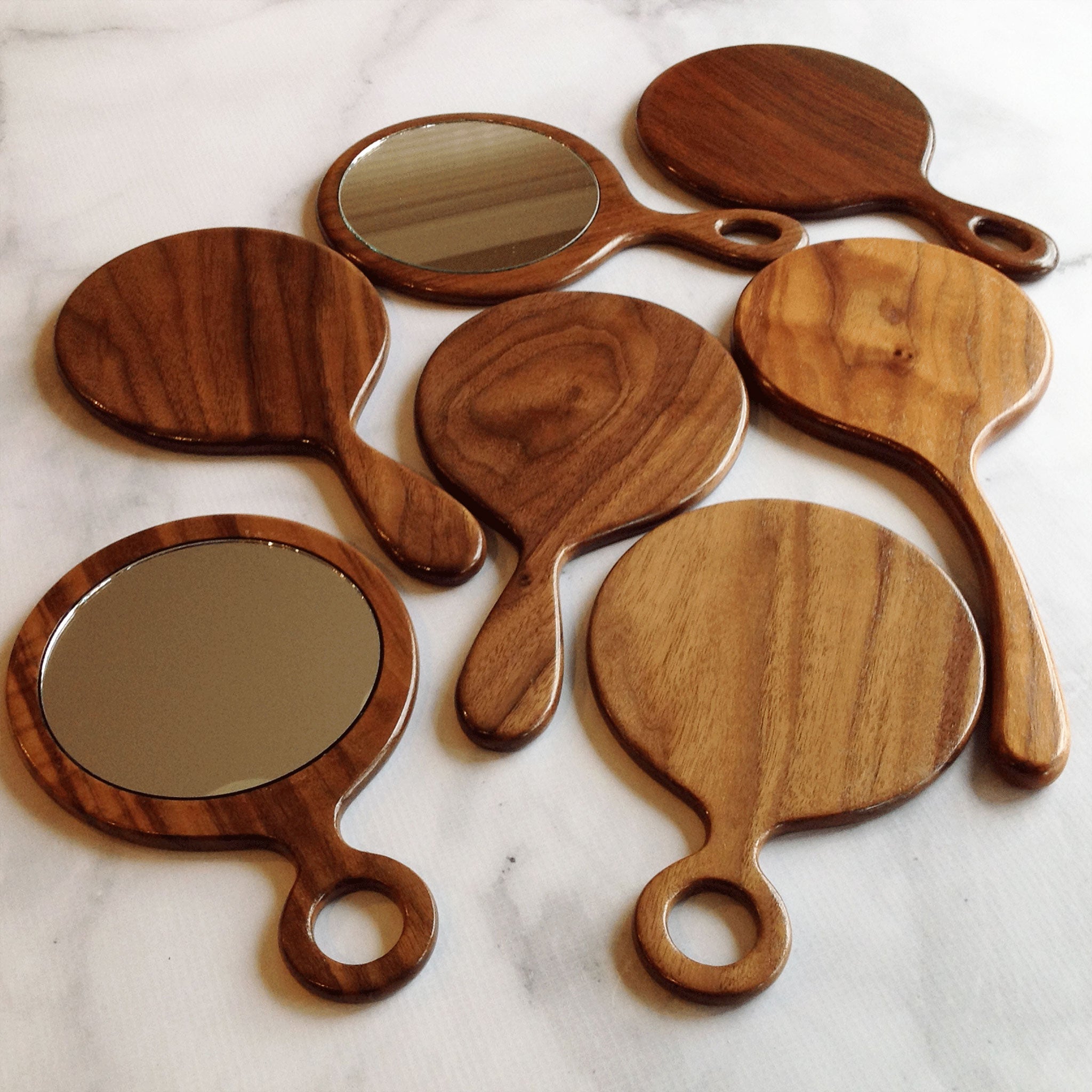 Five different walnut hand mirror vanity hand held mirror designs by Michael's Woodcrafts Greenville SC woodworkers woodworking artist