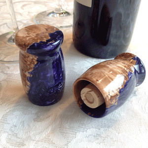 Beautiful high gloss finished wine bottle stopper with maple burl and purple resin handcrafted on the wood lathe