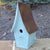large bluebird house painted country blue with brown tin tall pointed roof