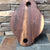 Round Walnut serving board with handles on each end and holes in handle  by Michael's Woodcrafts Greenville SC woodworkers woodworking