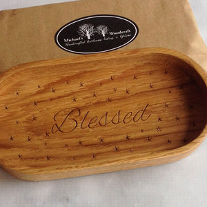 Catchall tray with the word blessed engraved inside it.