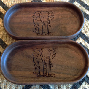 Two handcrafted walnut catchall trays both have an elephant walking toward you engraving on the bottom  by Michael's Woodcrafts Greenville SC woodworker Woodworking artist woodworkers